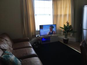 a living room with a couch and a flat screen tv at Brookfield’s Apartment in Clacton-on-Sea
