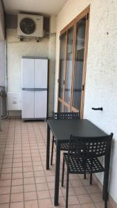 a black table and two chairs on a patio at B&B La Finestra sui Trabocchi in San Vito Chietino