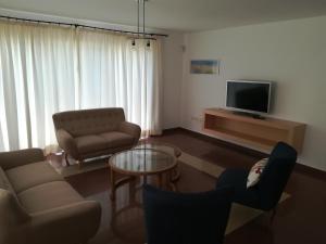 a living room with a couch and a tv at Vivienda Unifamiliar Sela in Santa Cruz de Tenerife