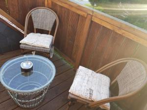 a porch with two chairs and a table at Heimathafen in Neufolstenhausen