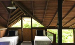 Ein Bett oder Betten in einem Zimmer der Unterkunft Pousada Rainforest House - Ilha Grande