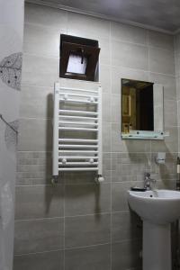 a bathroom with a sink and a mirror at Guest House on Meskheti in Borjomi +37 photos