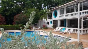a house with a swimming pool in front of it at Coral House San Andres in San Andrés