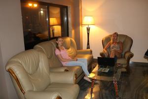 two women sitting in chairs in a hotel room at Hotel Aristocrat Batumi in Batumi