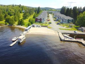 a boat is docked at a dock in the water at Condo Lac Archambault 298 in Saint-Donat-de-Montcalm
