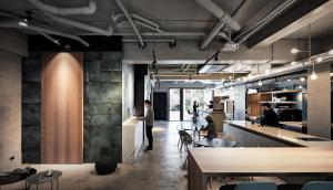 a lobby of a restaurant with people sitting at tables at Waterfront Hotel in Taipei