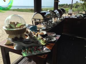 a buffet of food on a table near the beach at Nilaveli Beach Resort - Level 1 Certified in Nilaveli