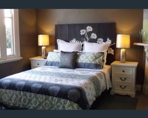a bedroom with a large bed with two night stands at Eureka Views B&B Ballarat in Ballarat