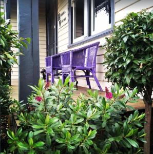 a purple bench sitting on the porch of a house at Eureka Views B&B Ballarat in Ballarat