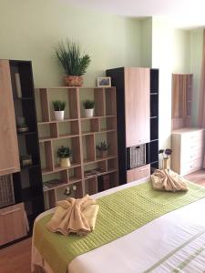 a bedroom with a bed with two towels on it at Siana 1 Apartment in Sveti Vlas +96 photos
