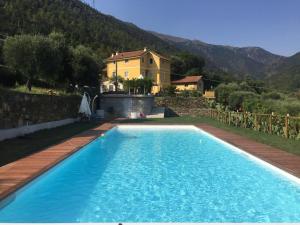 a swimming pool in front of a house at Agriturismo Argentea in Arenzano