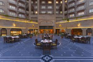 a restaurant with tables and chairs in front of a building at Park Plaza, Ludhiana in Ludhiana