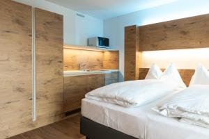 a bedroom with a bed and a dresser at Jet Hotel Zurich Airport in Rümlang