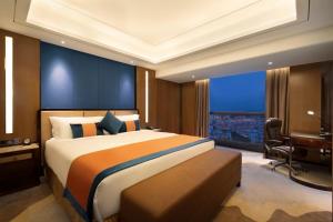 Voodi või voodid majutusasutuse Ramada Foshan Nanhai toas