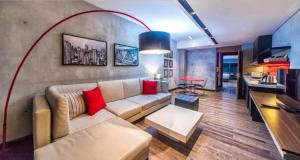 a living room with a couch and a table at The B Hotel Quezon City in Manila