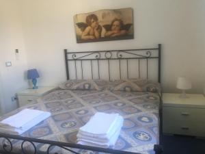 a bedroom with a bed with two towels on it at Villa Azzurra in San Felice Circeo