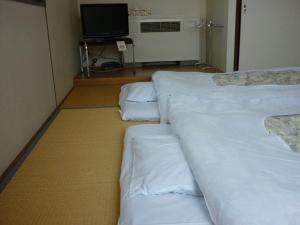 Ένα ή περισσότερα κρεβάτια σε δωμάτιο στο Stayful House Nakamachi