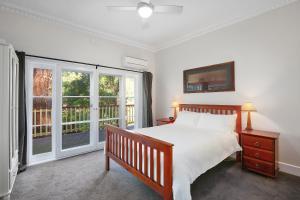 a bedroom with a bed and a large window at Charnwood Cottages in Warburton in Warburton