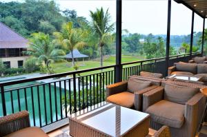 a balcony of a resort with chairs and a table at Amanuba Hotel & Resort Rancamaya in Bogor