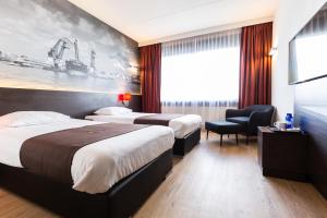 a hotel room with a bed and a desk at Bastion Hotel Rotterdam Alexander in Rotterdam