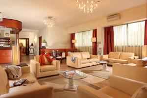 a large living room with couches and a table at Hotel Cassia in Rome