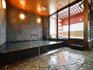 a swimming pool in a room with windows at Hotel WBF Grande Hakata in Fukuoka