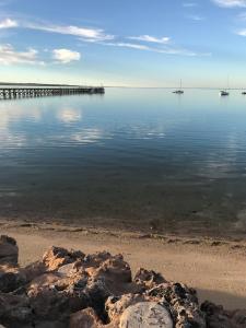 a large body of water with a pier at Beachside & Jetty View Apartment 6 - Captain's Apt in Streaky Bay