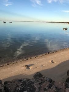 a beach with some boats in the water at Beachside & Jetty View Apartment 6 - Captain's Apt in Streaky Bay