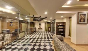 a living room with a checkered floor and furniture at Beyond Stay Lall Ji Tourist Resort in Dalhousie