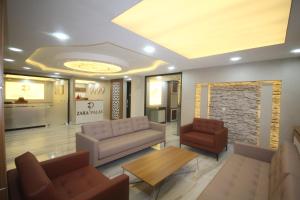 a lobby with a couch and a table and chairs at Zara Palas Otel in Zara