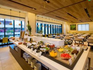 a breakfast buffet in a restaurant with tables and chairs at Hotel Monterey Le Frere Osaka in Osaka