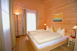 a bedroom with a bed in a wooden wall at Alpenchalets - Obholzer in Kühtai