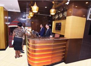 a group of people standing at a bar at Zagy Hotel in Dubai