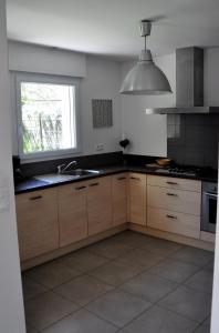 een keuken met een spoelbak en een raam bij Maison Roche Blanche in Port Blanc