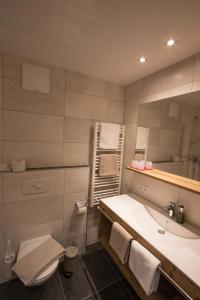 a bathroom with a sink and a toilet and a tub at Haus Sattelblick in Sankt Anton am Arlberg