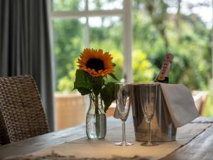 a vase with a sunflower in it on a table at Hygge Hus in Westerland