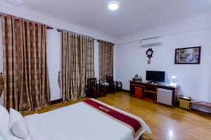 a hotel room with a bed and a television at A25 Hotel - 45B Giảng Võ in Hanoi