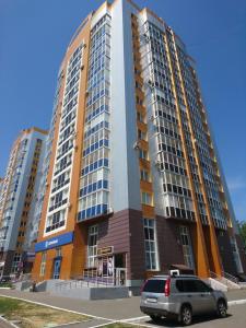 a van parked in front of a tall building at Studio Loft in Saransk