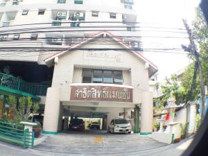 a building with a car parked in front of it at Sathitsit Mansion in Bangkok