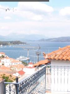 a balcony of a building with a view of the water at Sea view house on Poros in Poros