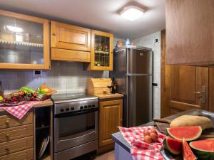 eine Küche mit Holzschränken und einem Kühlschrank aus Edelstahl in der Unterkunft Belvilla by OYO Giardino delle Giare in Castiglion Fiorentino