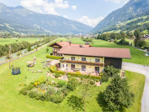 an aerial view of a house in a green field at Appartement Achenhof in Bad Hofgastein