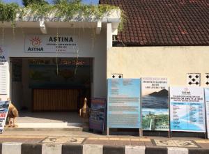 a building with two signs in front of it at Astina Hotel in Lovina