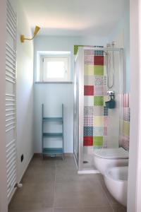 a bathroom with a toilet and a sink and a shower at La Basiglia B&B in Monforte dʼAlba