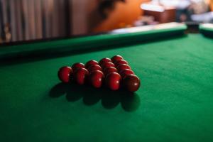 a group of red balls on a pool table at SinhaGiri Mansion in Nuwara Eliya