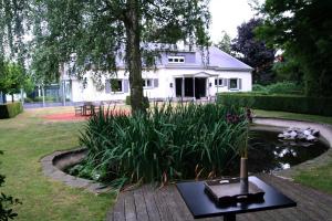 a vase on a table in front of a house at Villa Pura Vida in Kortrijk