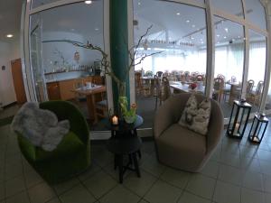 a restaurant with two chairs and a table and a dining room at Hotel Landgasthaus Schäferhof in Alsfeld