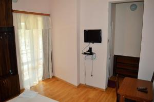 a room with a room with a television on the wall at Hotel Tedi in Kvareli