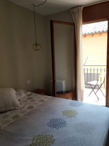 a bedroom with a bed and a view of a patio at Ca la Pagesa in Sant Llorenç de Morunys