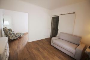 a living room with a couch and a chair at Vinha da Areia Beach Hotel in Vila Franca do Campo